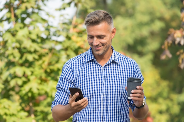 Waiting for message. Modern life demands modern gadgets. Man with smartphone drinking coffee. Mobile phone always with me. Man use smartphone. Internet surfing social networks with smartphone.