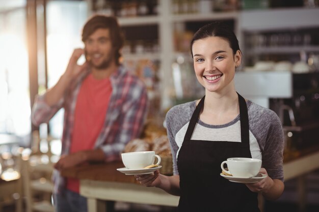  waitress holding coffee cups