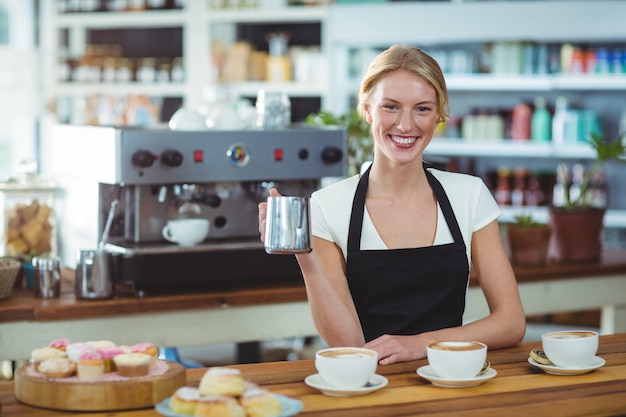  waitress making cup of coffee at counter