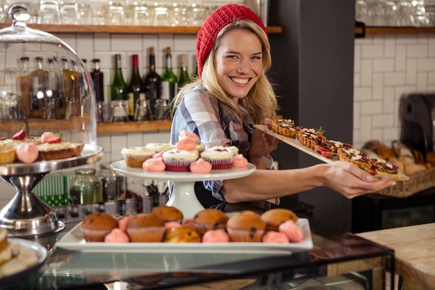 Waitress posing with cakes