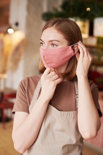 Waitress Putting On Mask