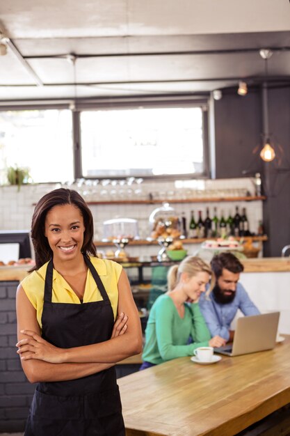 Waitress standing with arms crossed