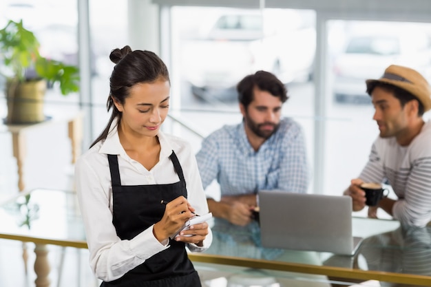 Waitress taking an order in cafe