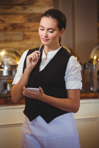 Photo waitress taking order on a notebook