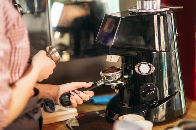 Waitress using a coffee machine