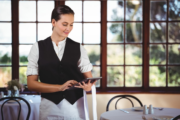 Waitress using digital tablet