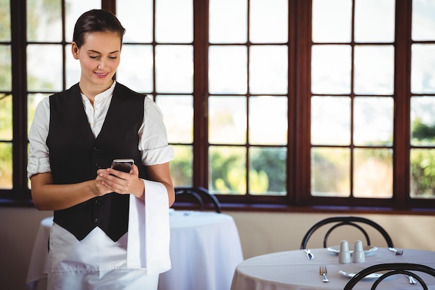 Photo waitress using mobile phone