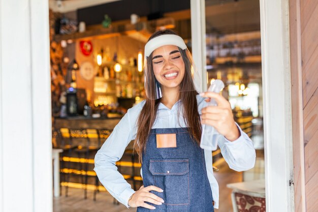 Waitress with face shield greeting customers