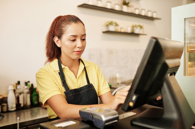 Waitress Working at Cashier Desk