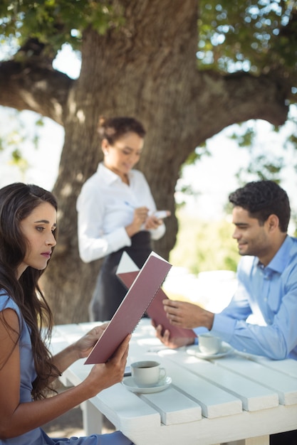 Waitress writing order on notepad