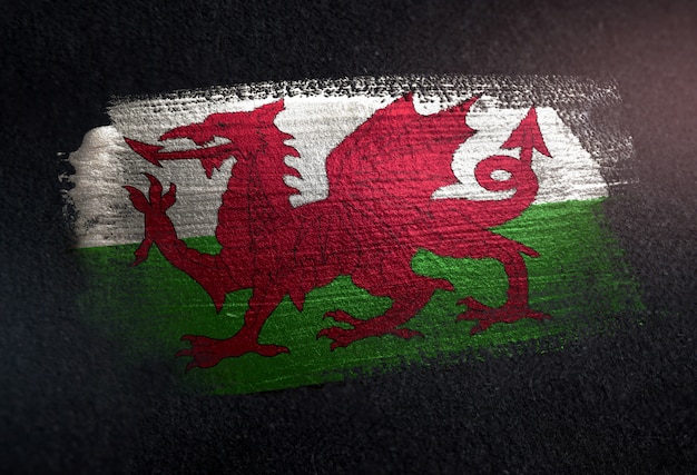 Photo wales flag made of metallic brush paint on grunge dark wall