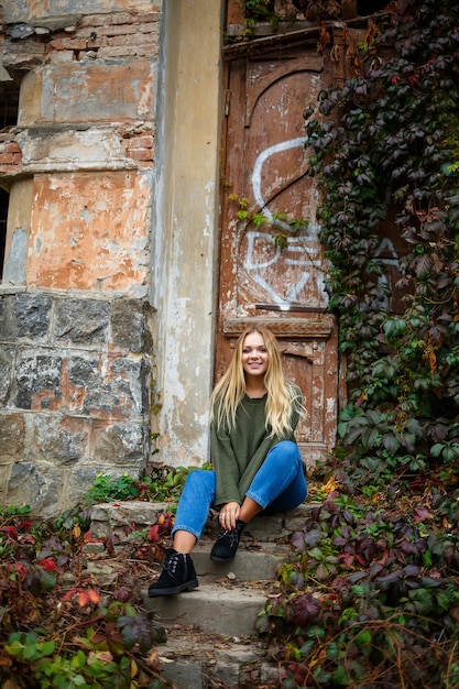 Walk of a beautiful girl in a sweater and jeans