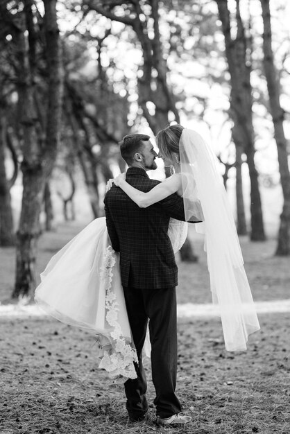 Walk of the bride and groom through the autumn forest in October