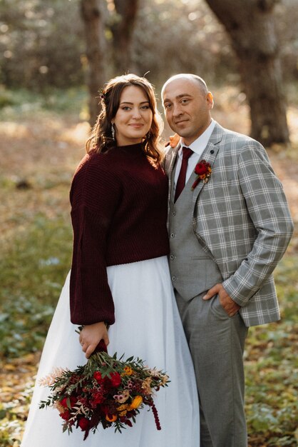 Walk of the bride and groom through the autumn forest in October