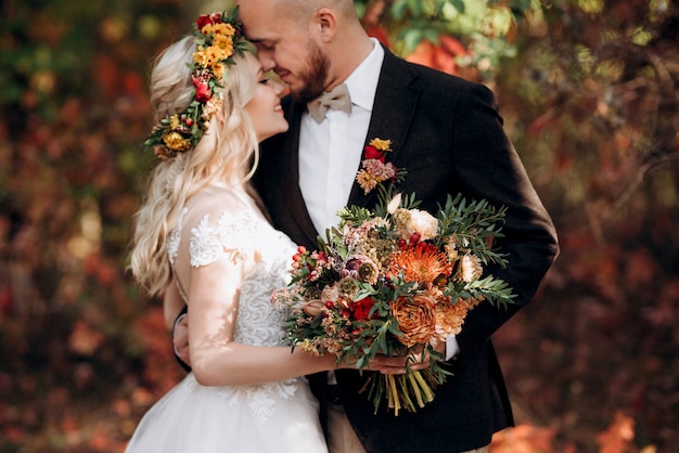 Walk of the bride and groom through the autumn forest