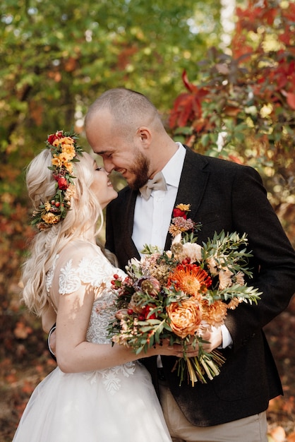 Walk of the bride and groom through the autumn forest