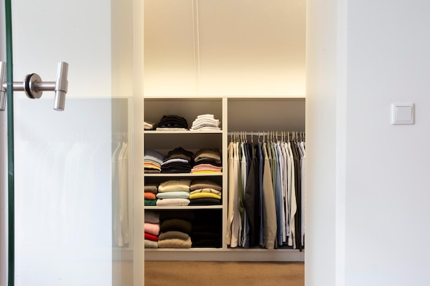 Walk in closet with cloth and shelf at home modern stylish white design interior storage concept