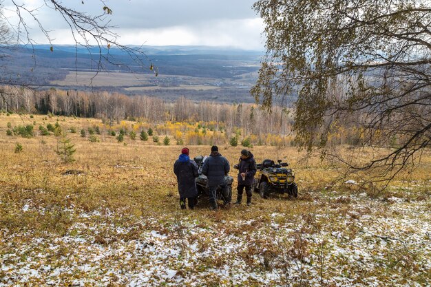 Walk on cross-country vehicles. Travelers drink tea with a view of the mountains of the Urals.