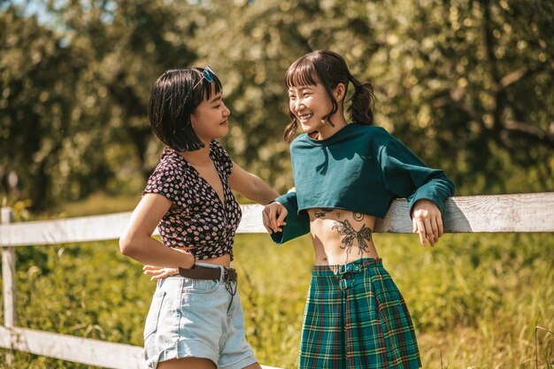 Walk in the park. Sweet girls looking happy and ejoyed while spending time together