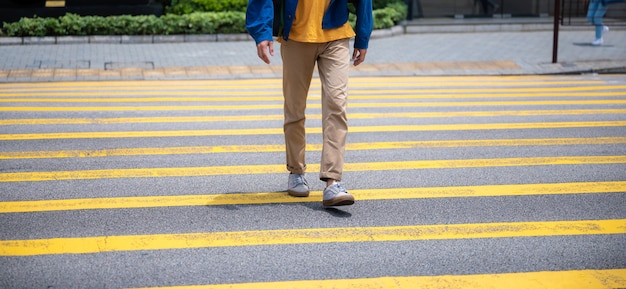 Walking across a pedestrian crossing, On foot across large city streets Conceptual images of basic rights to use of public areas