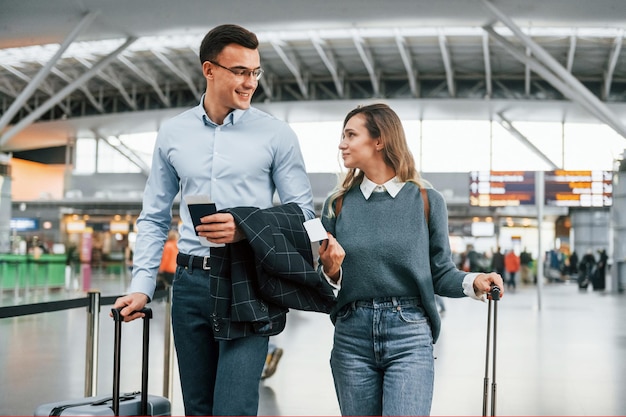 Walking indoors Young couple is in the airport together