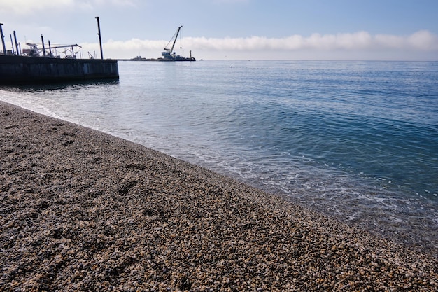 Walking on the shore of the Black Sea. Vacation at a recreation center near the seashore.