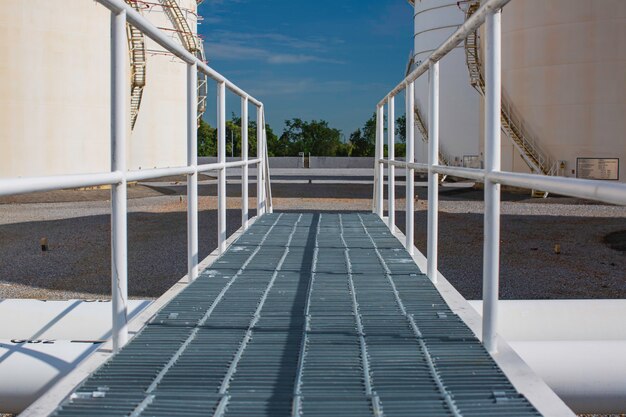 Walking stairs on the tank white blue sky.