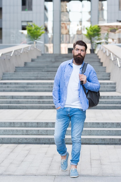 Walking through empty streets. Renaissance after coronavirus lockdown. Modern life. Social distancing. Change of scenery concept. Handsome hipster with backpack walking street. Man traveler backpack.