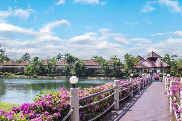 A walkway along the lake with a view of the resort.