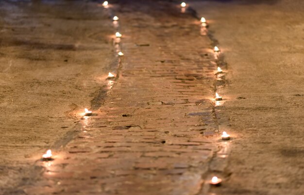 The walkway is decorated with small candles on the floor.