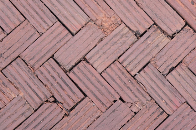 Walkway is paved with brown bricks