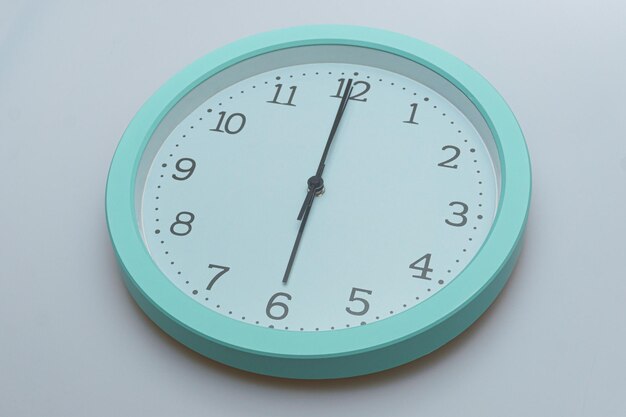 Wall clock showing various times on a white background