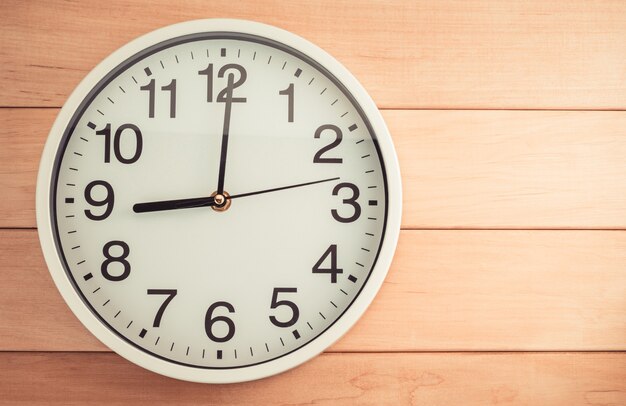 Wall clock on wooden table