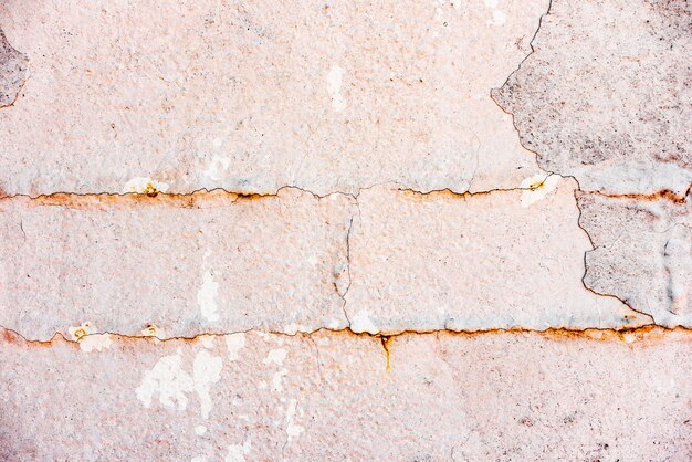 Wall fragment with scratches and cracks