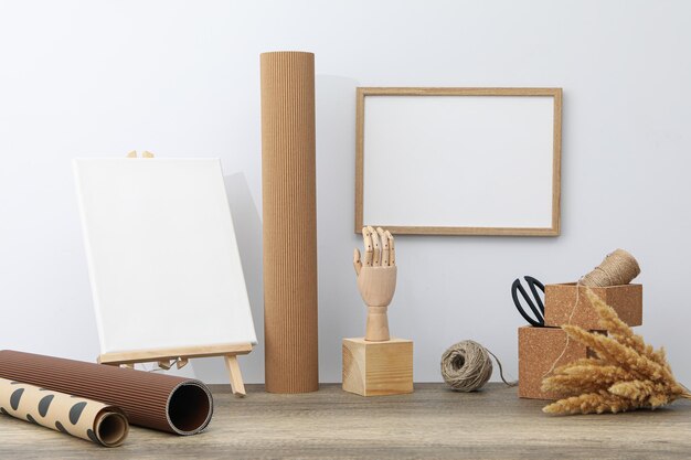 A wall frame and an easel on a craftsman's desk