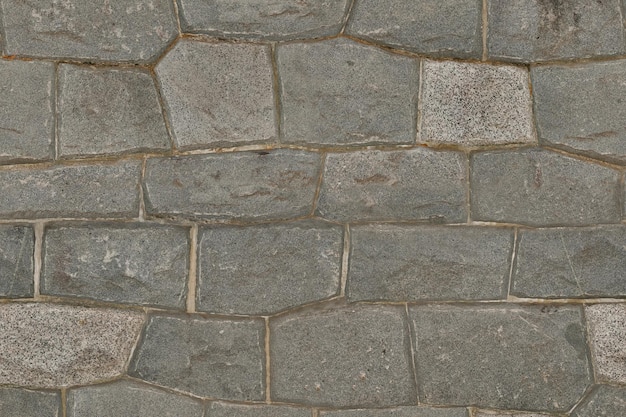 Photo a wall of grey stones with the word stone on it