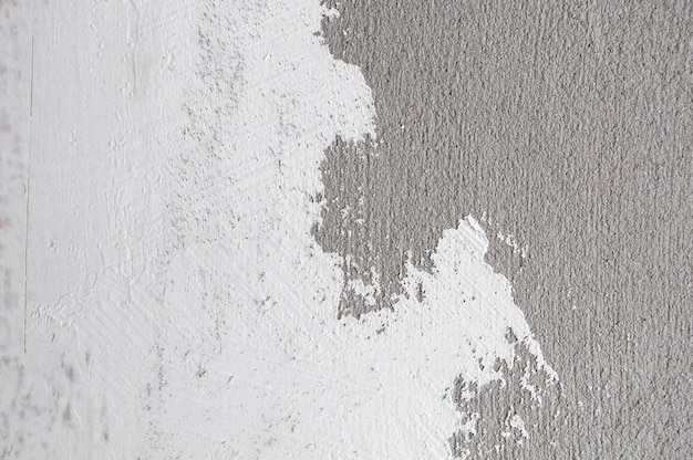 Foto parete grunge sfondo grigio cemento muro dirtydust muro cemento texture e schizzi di colore bianco.