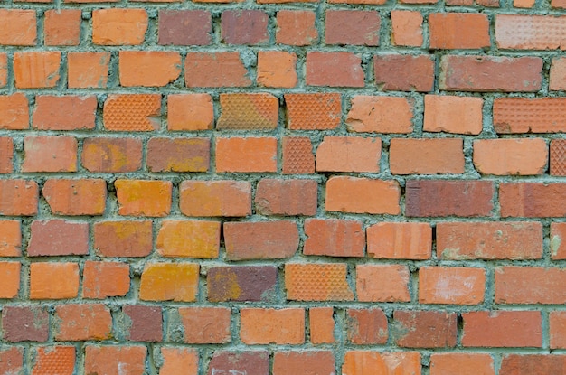 The wall is made of bricks of different colors.