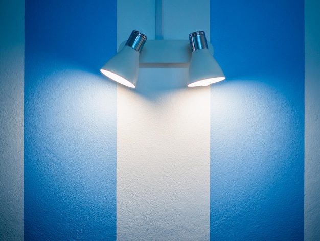 Wall lamp on white and blue wall background