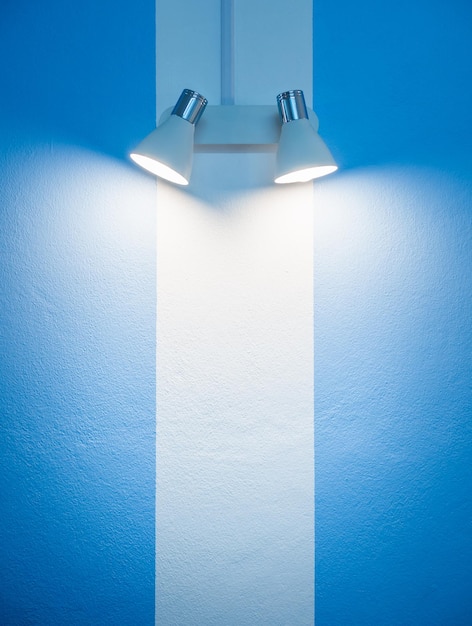 Wall lamp on white and blue wall background