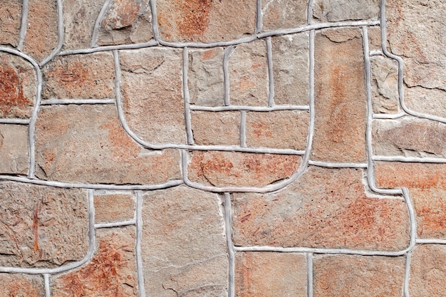 Foto parete rivestita con pietre irregolari di diverse forme di sfondo a trama uniforme