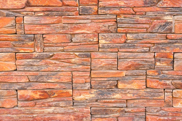 Wall lined with red stone background texture