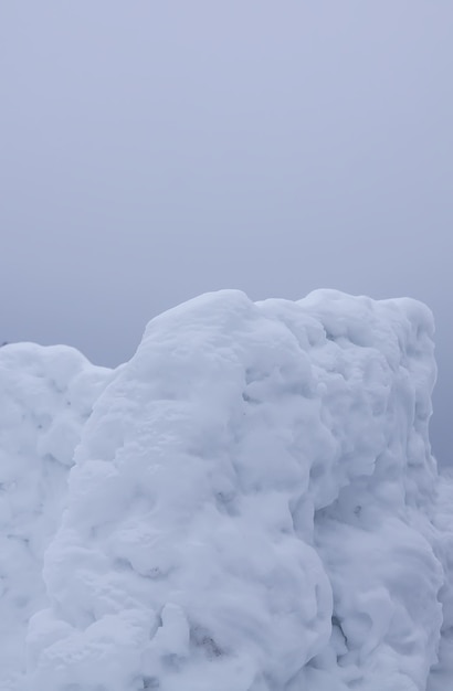 Wall made of snow on rural field.