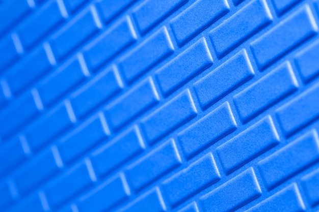 Wall of metallic bricks blue background