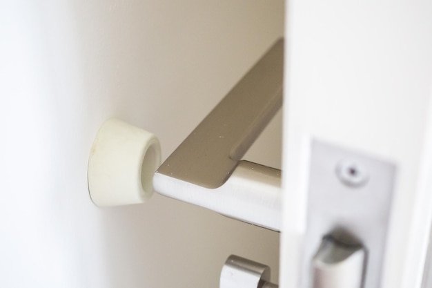 Wall mounted door stopper with modern door handle