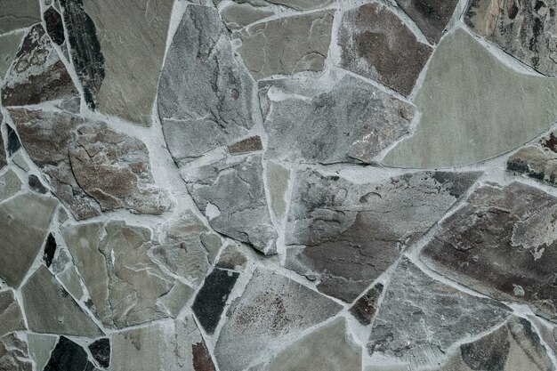 Photo wall of natural large granite stones bonded to each other with cement