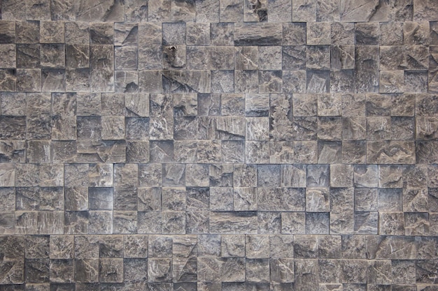 The wall of natural stone untreated Decorative stone Black stone background