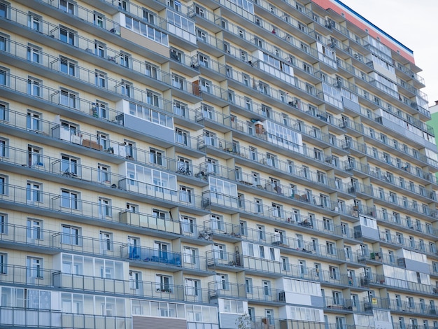 Wall of a new large residential building Same windows and balconies