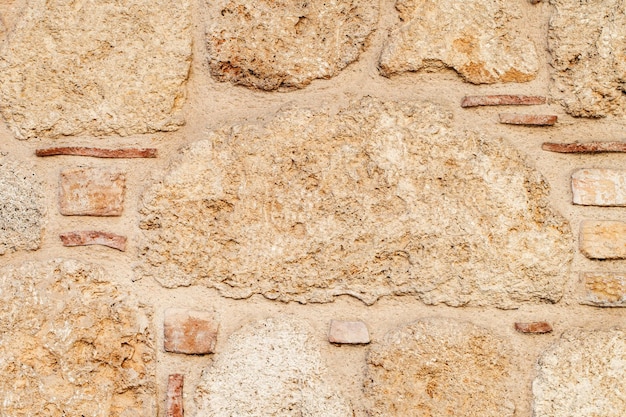 壁の古い石積みの古代の石のクローズ アップの背景