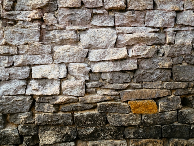The wall of old stone gray.